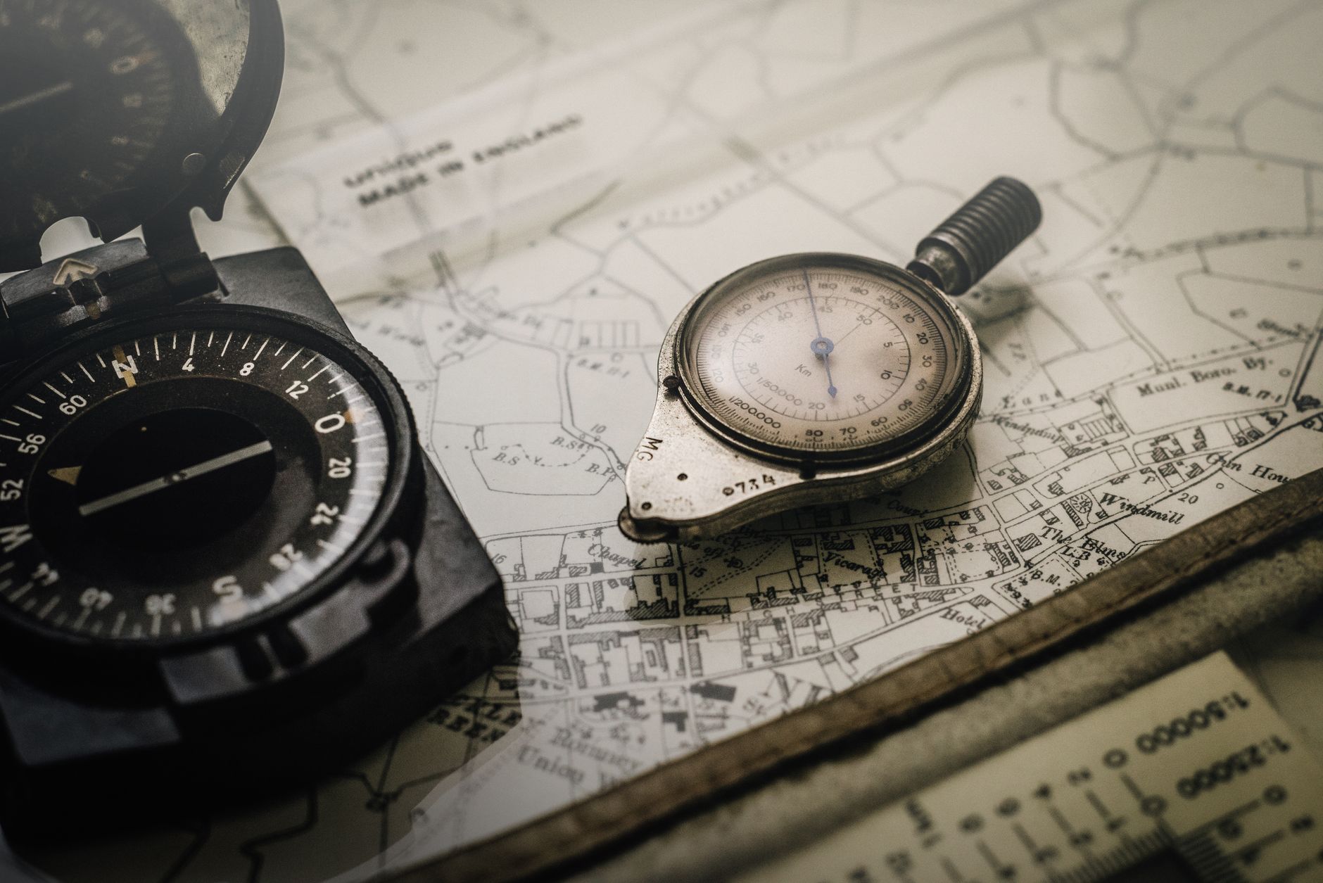 Aged hand-drawn maps spread across a candlelit desk, evoking the best portal fantasy dark fantasy novels UK 2026