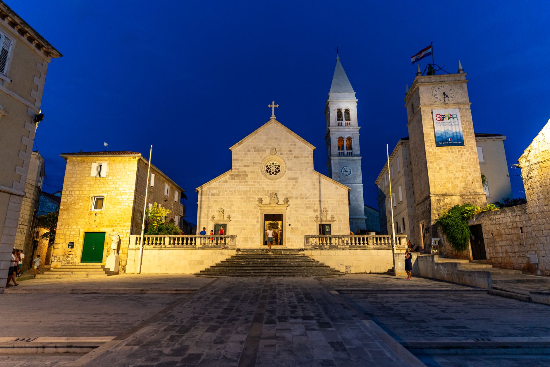 A medieval church bell tower at midnight, the setting for a festive horror short story about midwinter dark fiction