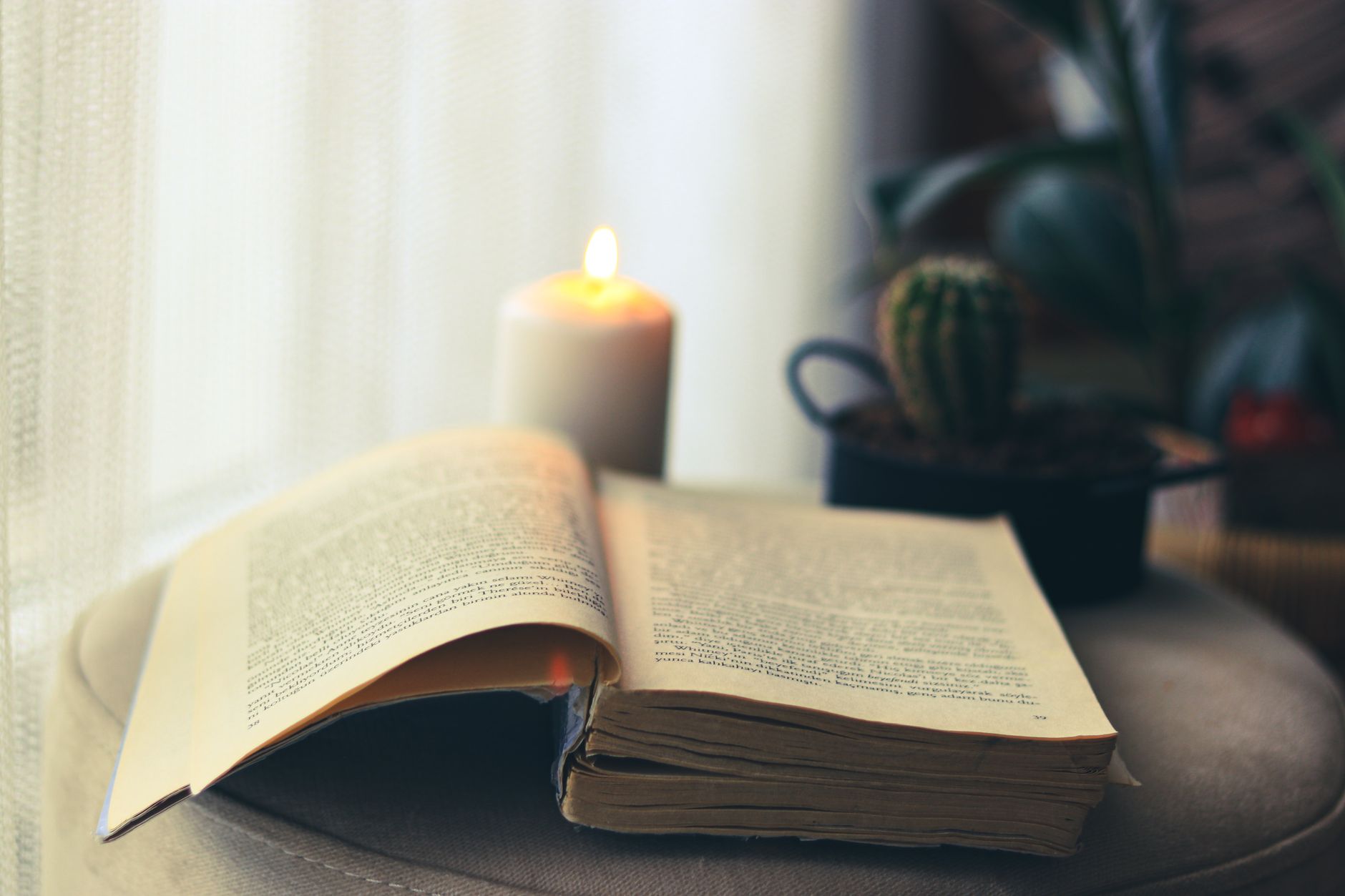 An ancient handwritten codex by candlelight, evoking the hidden texts found in festive horror novels